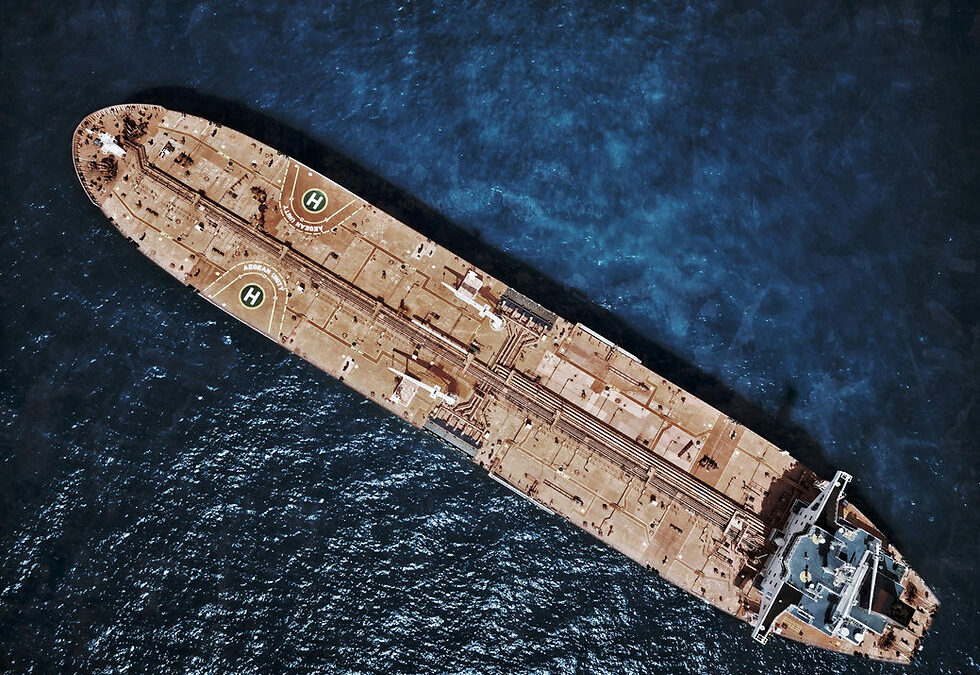 Aerial view of a large brown oil tanker in the ocean with two helipads marked "H" and "NORIENT SPLENDOUR" against blue water.